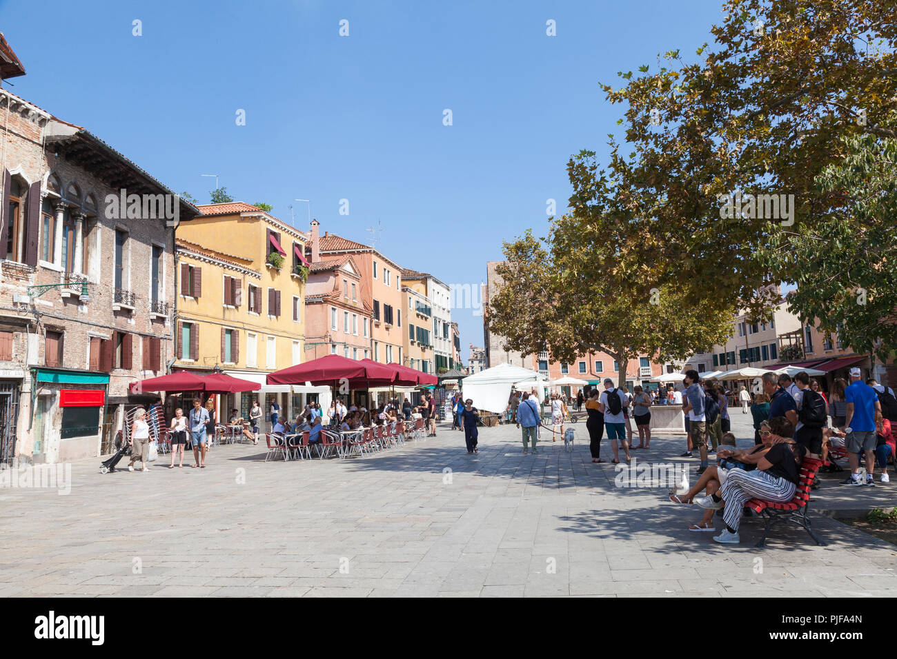 People eating at open air restaurants, Campo Santa Margherita, Dorsoduro, Venice,  Veneto, Italy on a sunny autumn day. Stock Photo