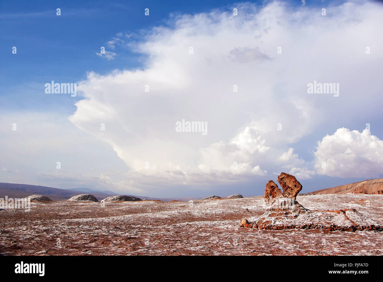 The rock of red sandstone on the background of amazing  cloudy sky  in  the Moon Valley, Atacama desert, Chile Stock Photo