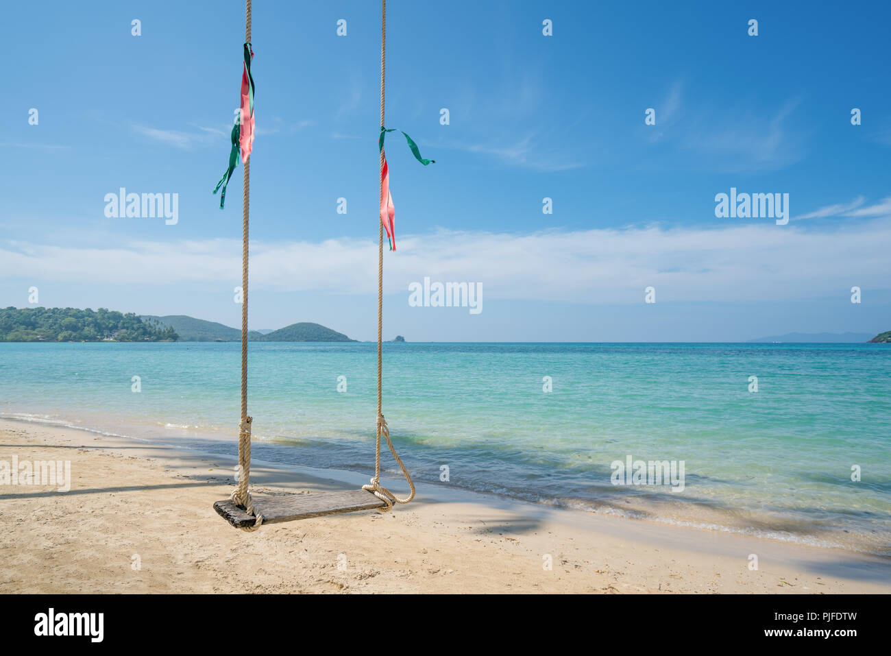 Swing hang from coconut palm tree over summer beach sea in Phuket ,Thailand. Summer, Travel, Vacation and Holiday concept Stock Photo