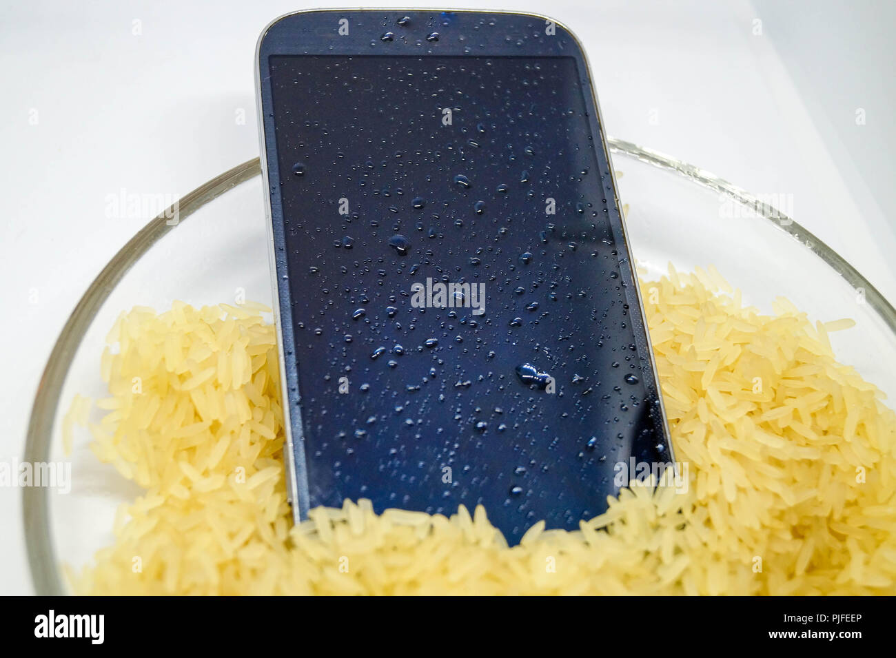 Wet mobile phone in rice Stock Photo Alamy