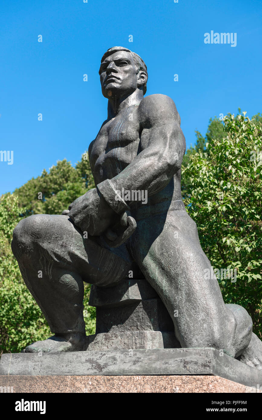 Communist monument, view of a Communist era statue of a powerful young nordic man in the Tallinn City Park and Gardens, Estonia. Stock Photo