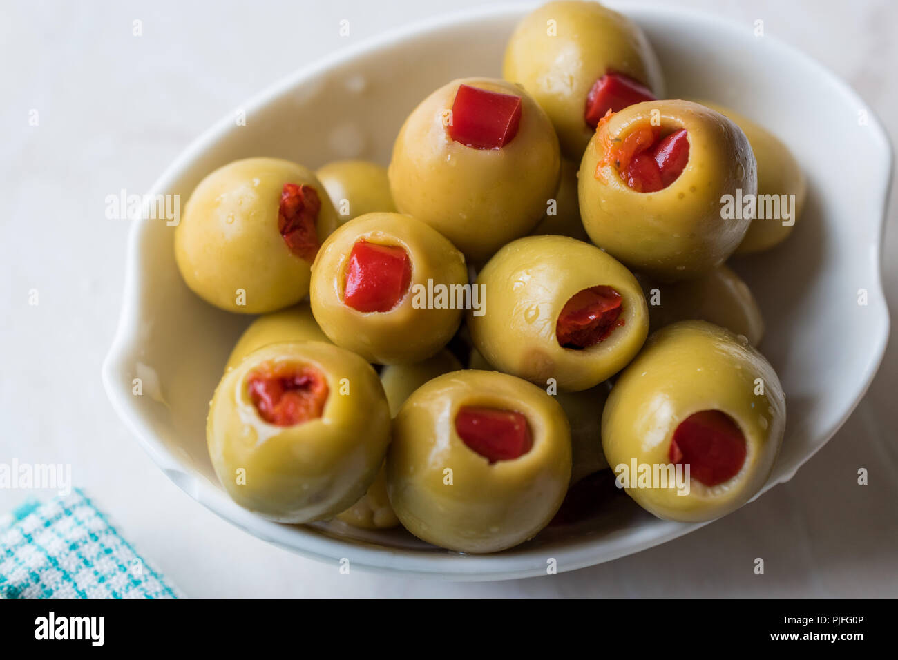 Green Olives Stuffed with Red Paprika Pepper. Organic Food Stock Photo