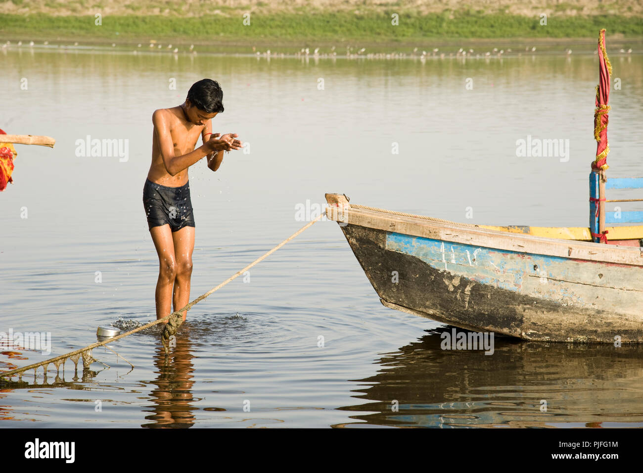 Boy worshiping with folded hands on bank of riverYamuna at Keshi Ghat   Vrindavan  Mathura  Uttar Pradesh  India Stock Photo