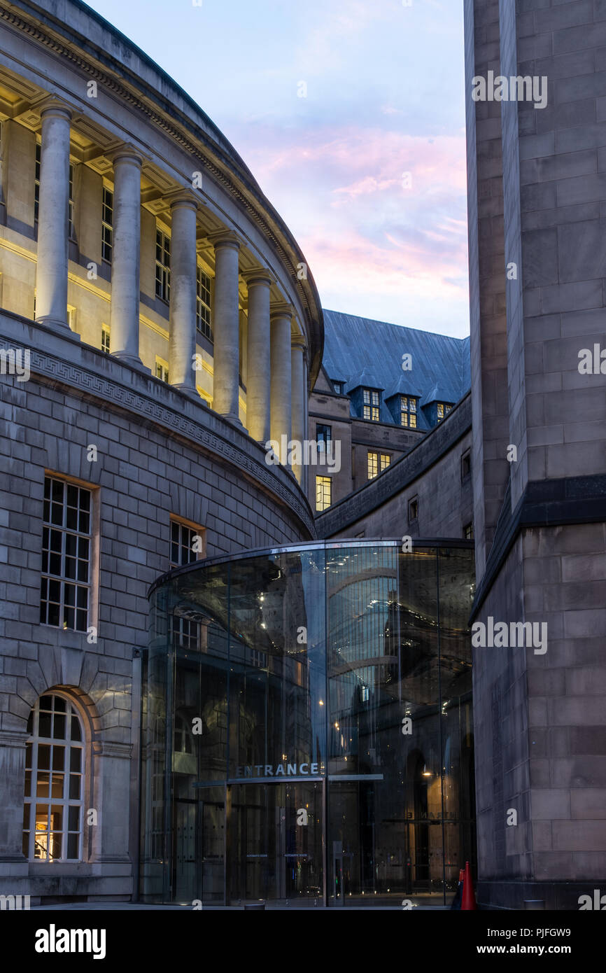 Manchester, ENgland, UK - July 1, 2018: The sun sets behind the modern entrance to Manchester's classical Central Library and Town Hall Extension buil Stock Photo
