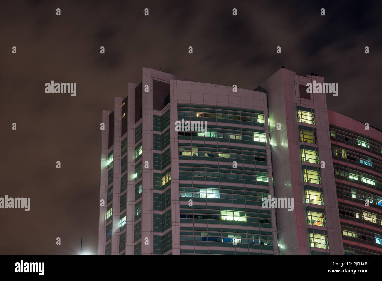 London, England, UK - February 27, 2018: The modern tower building of University College London Hospital (UCH) stands against the night sky in the Bl Stock Photo