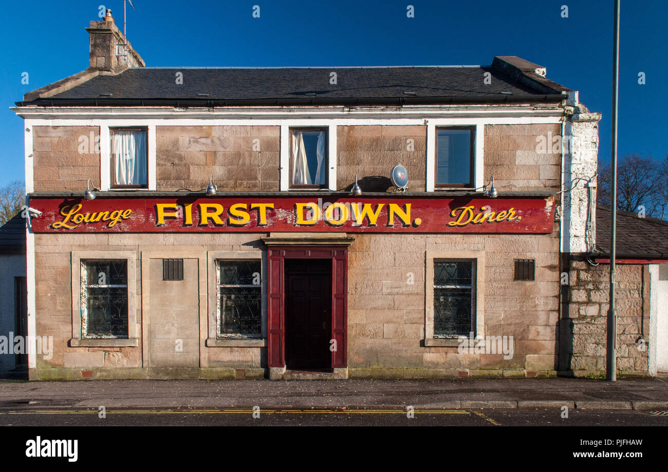 Falkirk, Scotland, UK - January 22, 2012: A colourful sign adorns the simple architecture of a traditional pub bar in Denny in central Scotland. Stock Photo