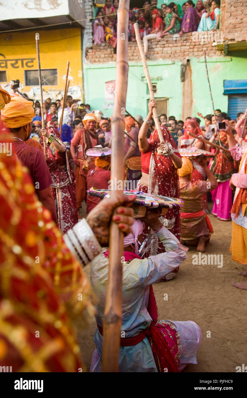 women and men Devotees they clelebrate Lathmar Holi Festival Indian women  beating men with sticks at nandgaon village in Mathura Uttar Pradesh Stock  Photo - Alamy