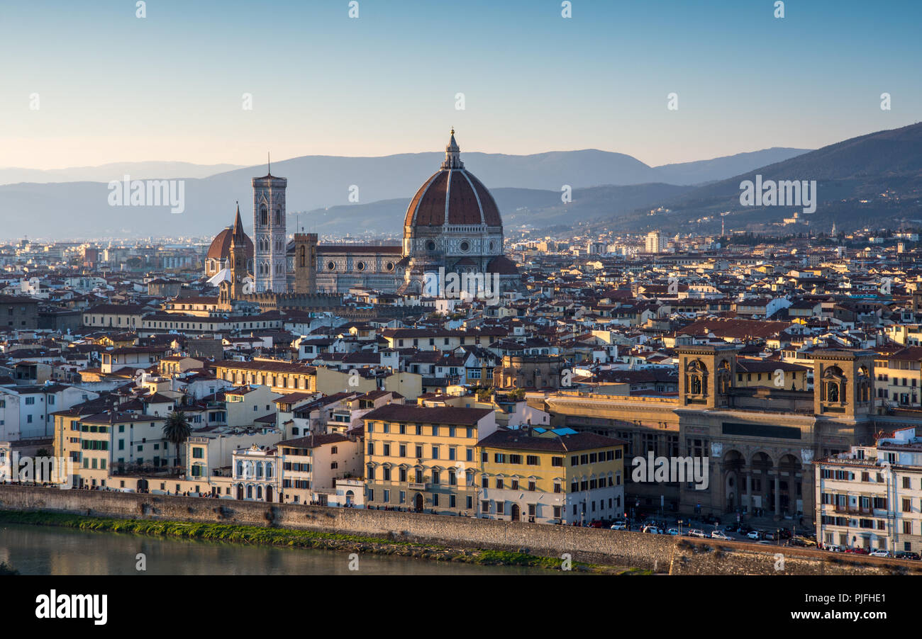 Florence, Italy - March 22, 2018: Landmarks including the Duomo cathedral stand in the Renaissance cityscape of Florence, with the hills of Monteferra Stock Photo