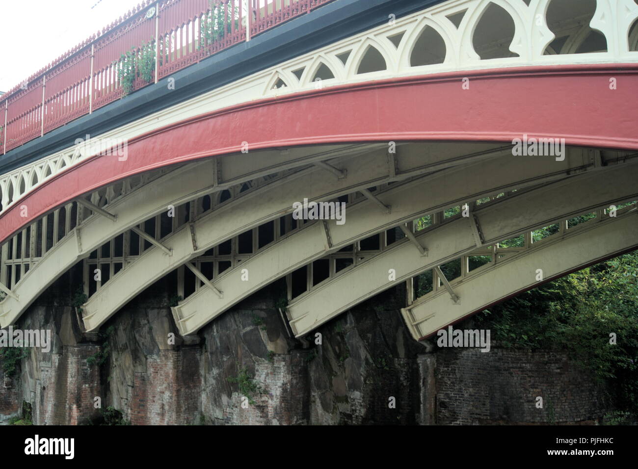 View of a cast iron railway bridge at Castlefields, Manchester, England. A close up view of the curved supports for this elegant and beautiful bridge. Stock Photo