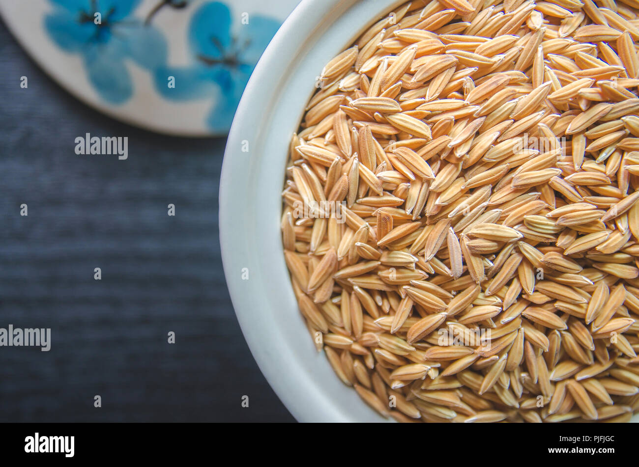 Top view of paddy rice and rice seed on dark wooden floor, Background ...