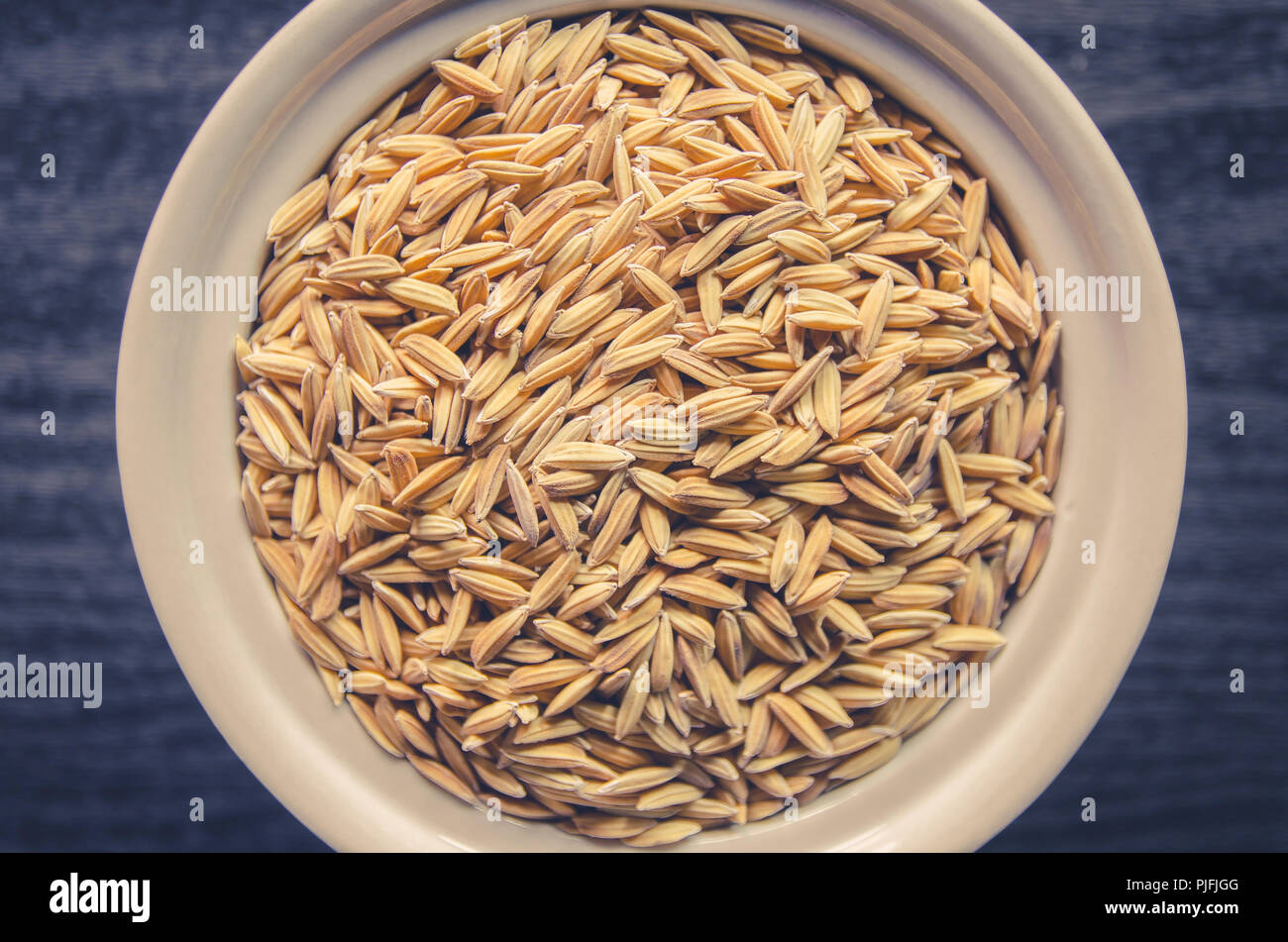 Top view of paddy rice and rice seed on dark wooden floor, Background ...