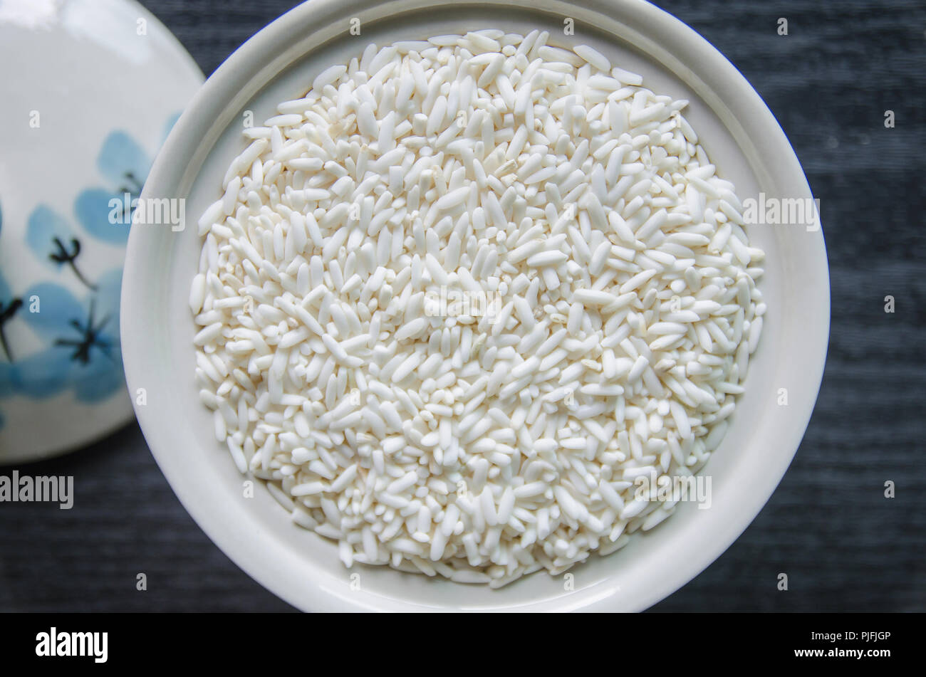 Top view of paddy rice and rice seed on dark wooden floor, Background ...