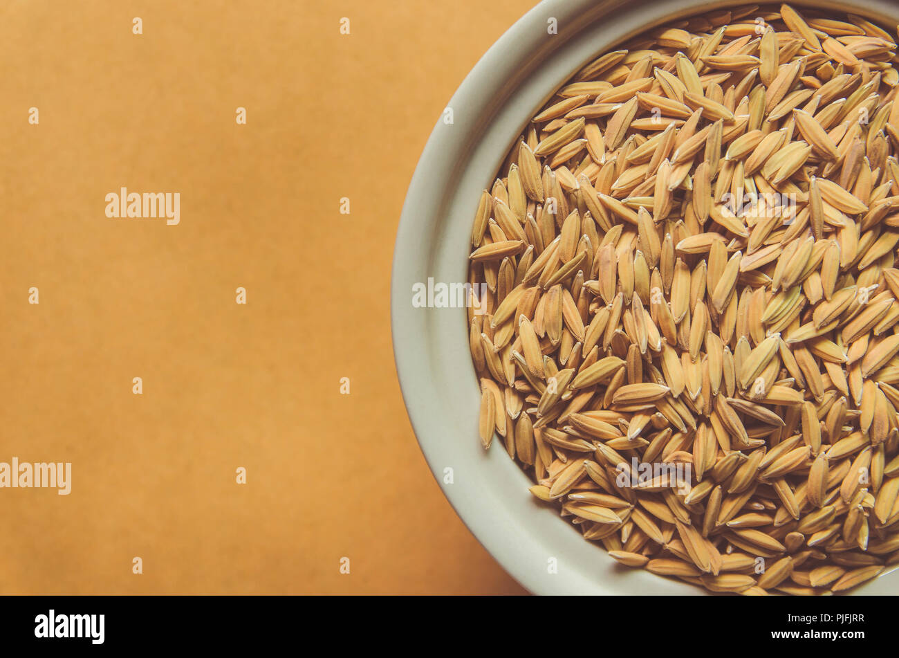 Top view of paddy rice and rice seed on the wooden floor, Background ...