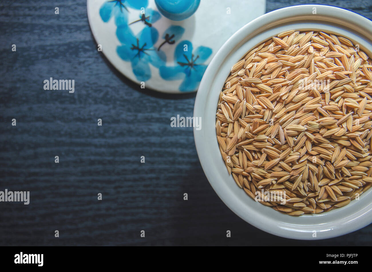 Top view of paddy rice and rice seed on dark wooden floor, Background ...