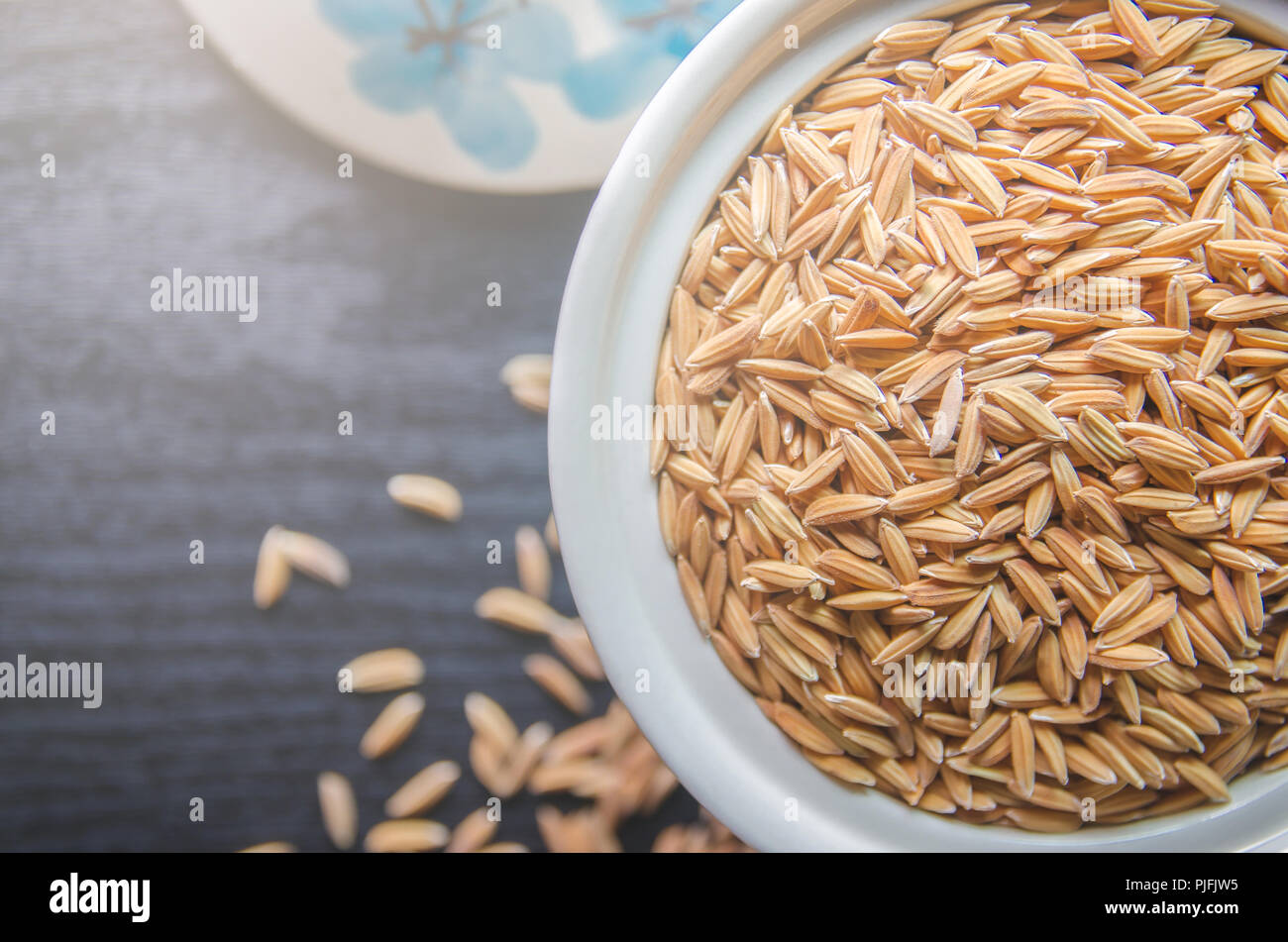 Top view of paddy rice and rice seed on dark wooden floor, Background ...