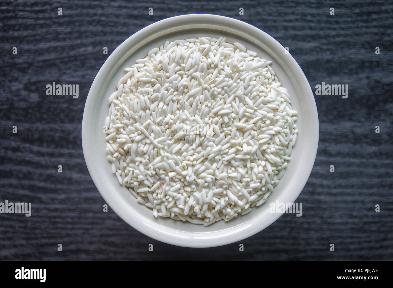 Top view of paddy rice and rice seed on dark wooden floor, Background ...