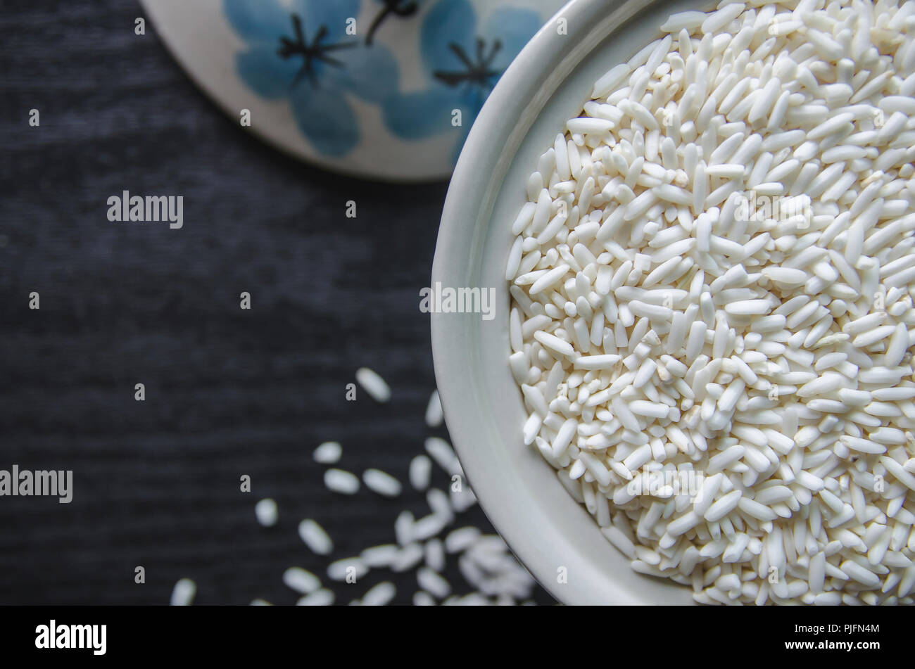 Top view of paddy rice and rice seed on dark wooden floor, Background ...