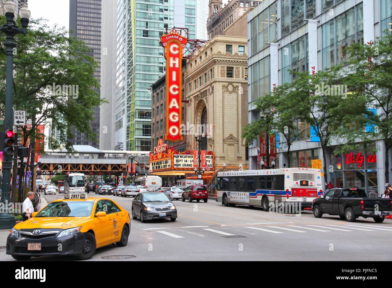CHICAGO, USA - JUNE 26, 2013: People walk past Chicago Theatre in Chicago. Chicago Theatre was founded in 1921 and is a registered Chicago Landmark. Stock Photo