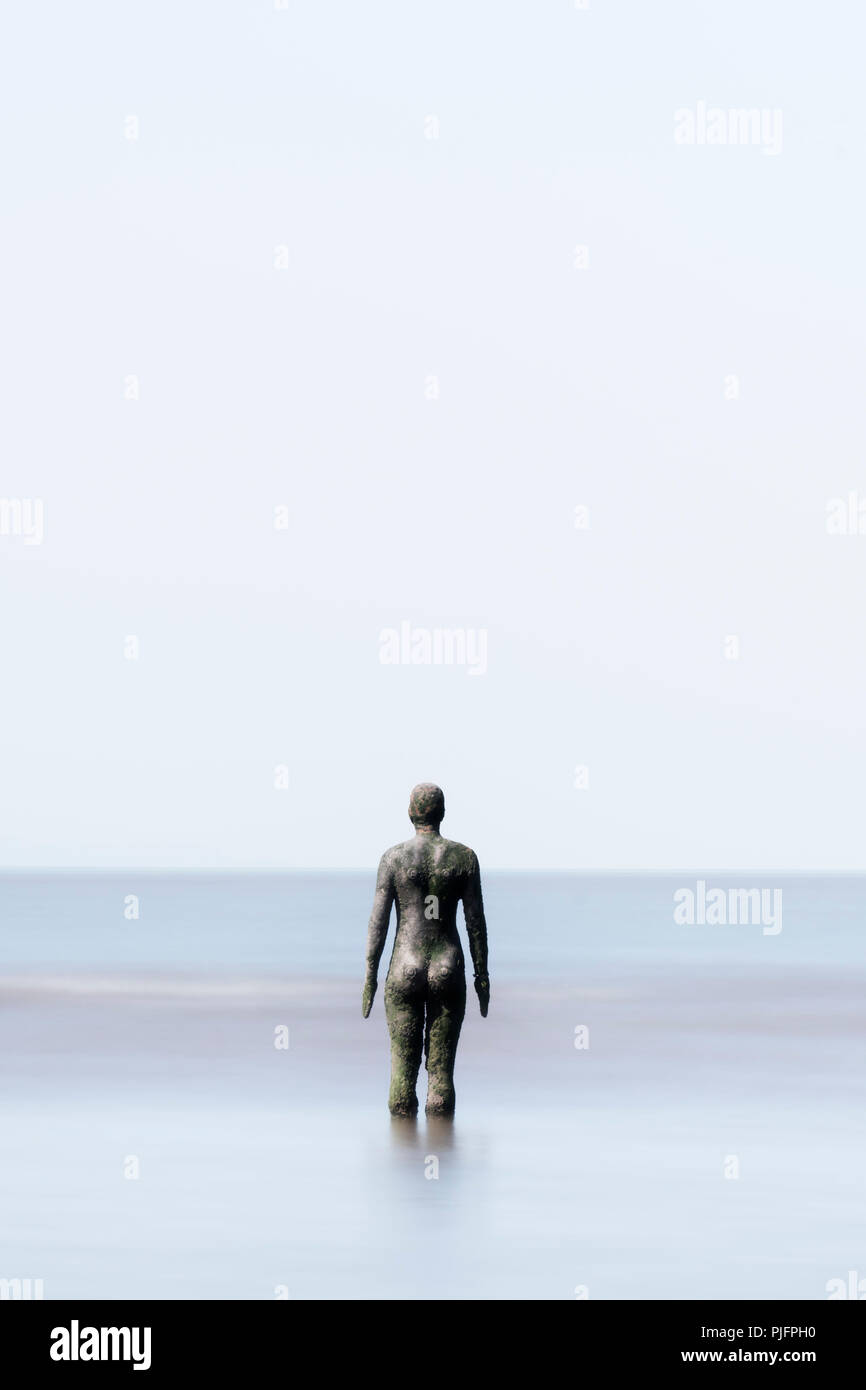 Figure from Antony Gormley's Another Place starting out into the Irish Sea, Crosby, Liverpool, England Stock Photo