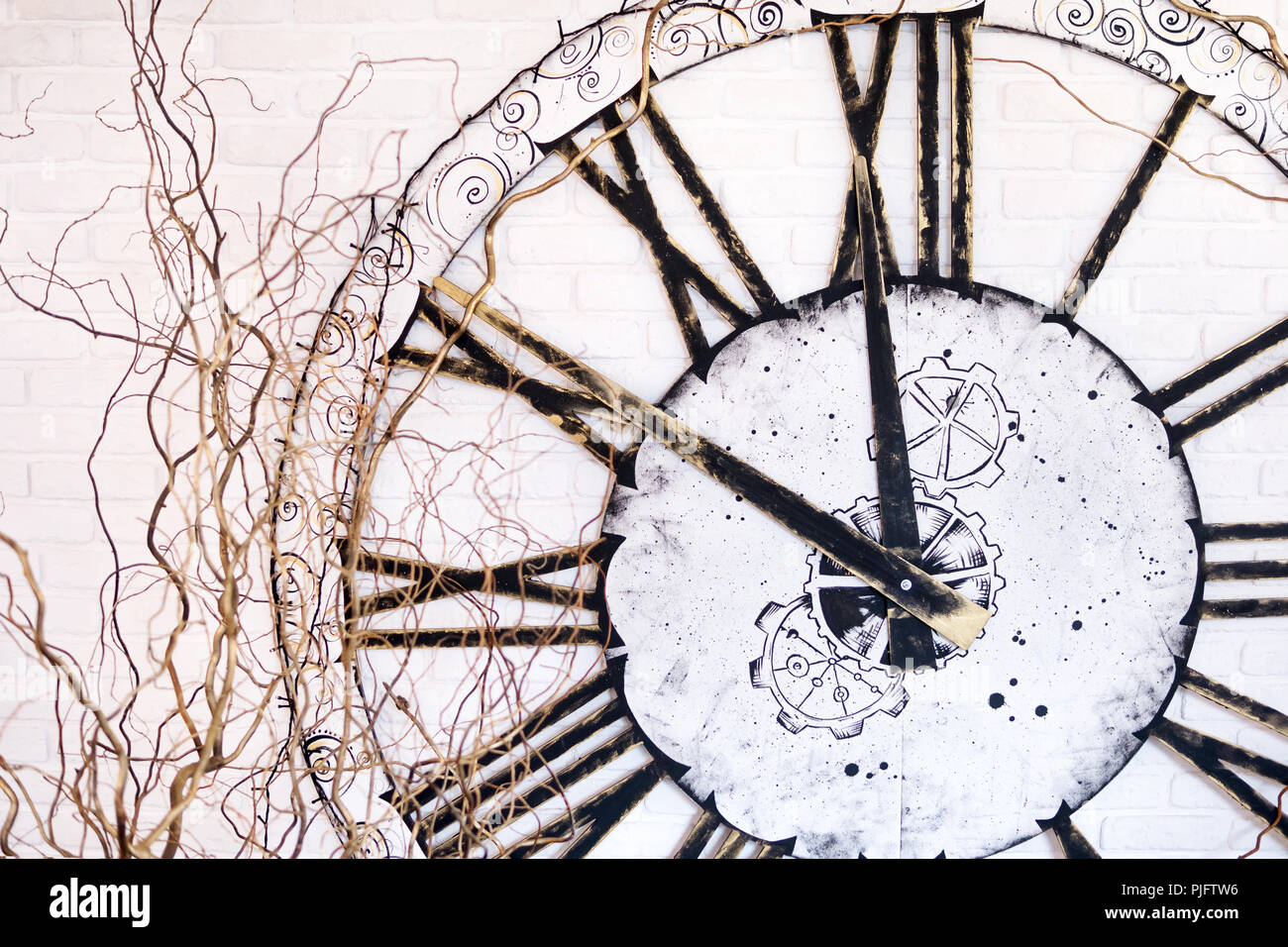 On the wall a large clock with Roman numerals showing at ten minutes to