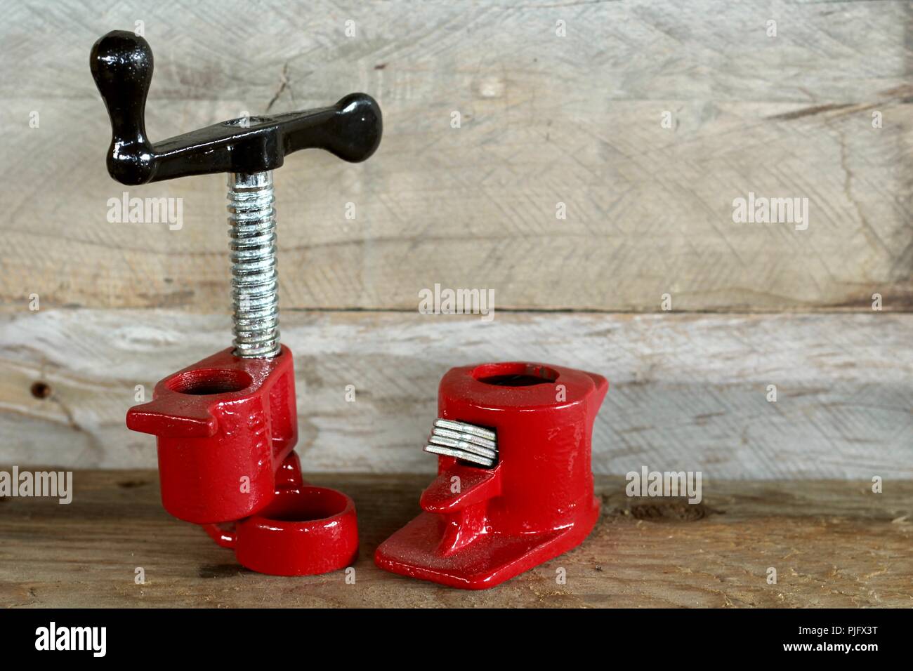 pipe clamp set red on a natural wood background Stock Photo