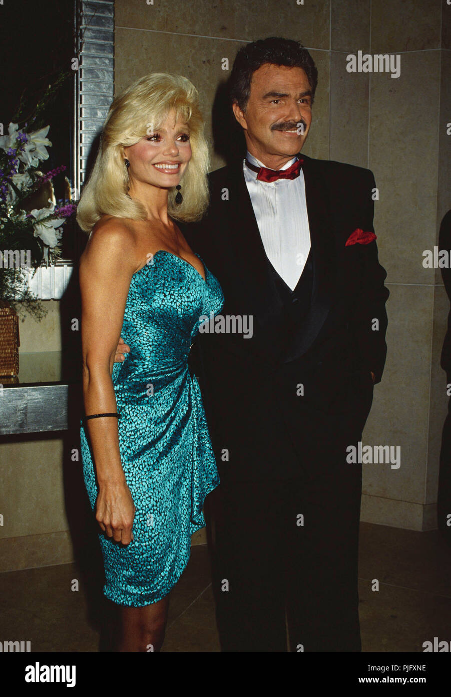 1991, USA --- Loni Anderson and Burt Reynolds --- ' Tsuni / Bourquard 'Burt Reynolds and Loni Anderson 362 Burt Reynolds and Loni Anderson 362 Stock Photo