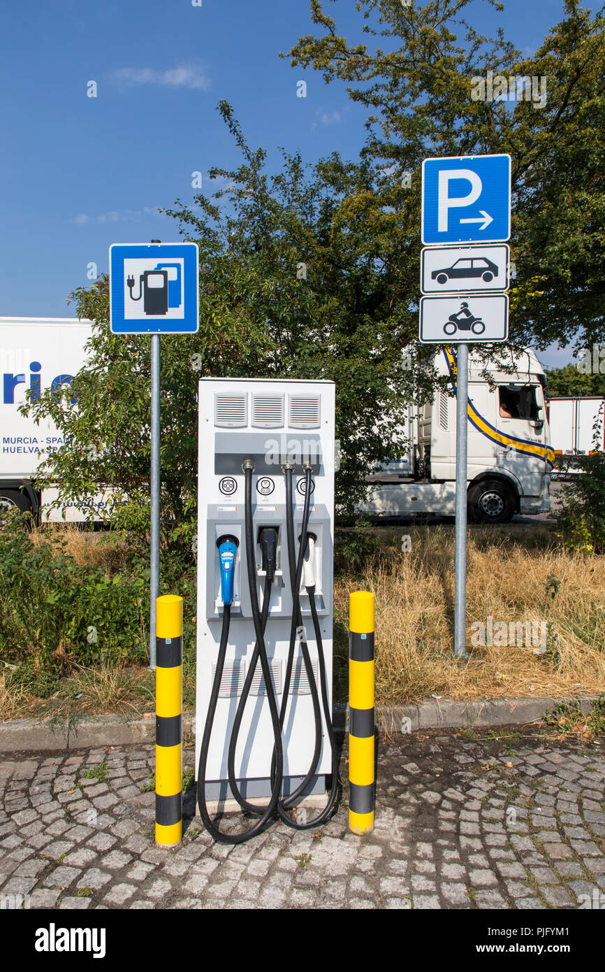 Charging station for electric vehicles, with charging cable and plug for various models, on a motorway service area, Germany Stock Photo