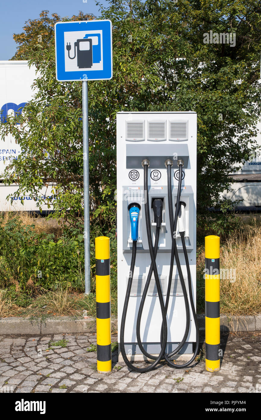 Charging station for electric vehicles, with charging cable and plug for various models, on a motorway service area, Germany Stock Photo