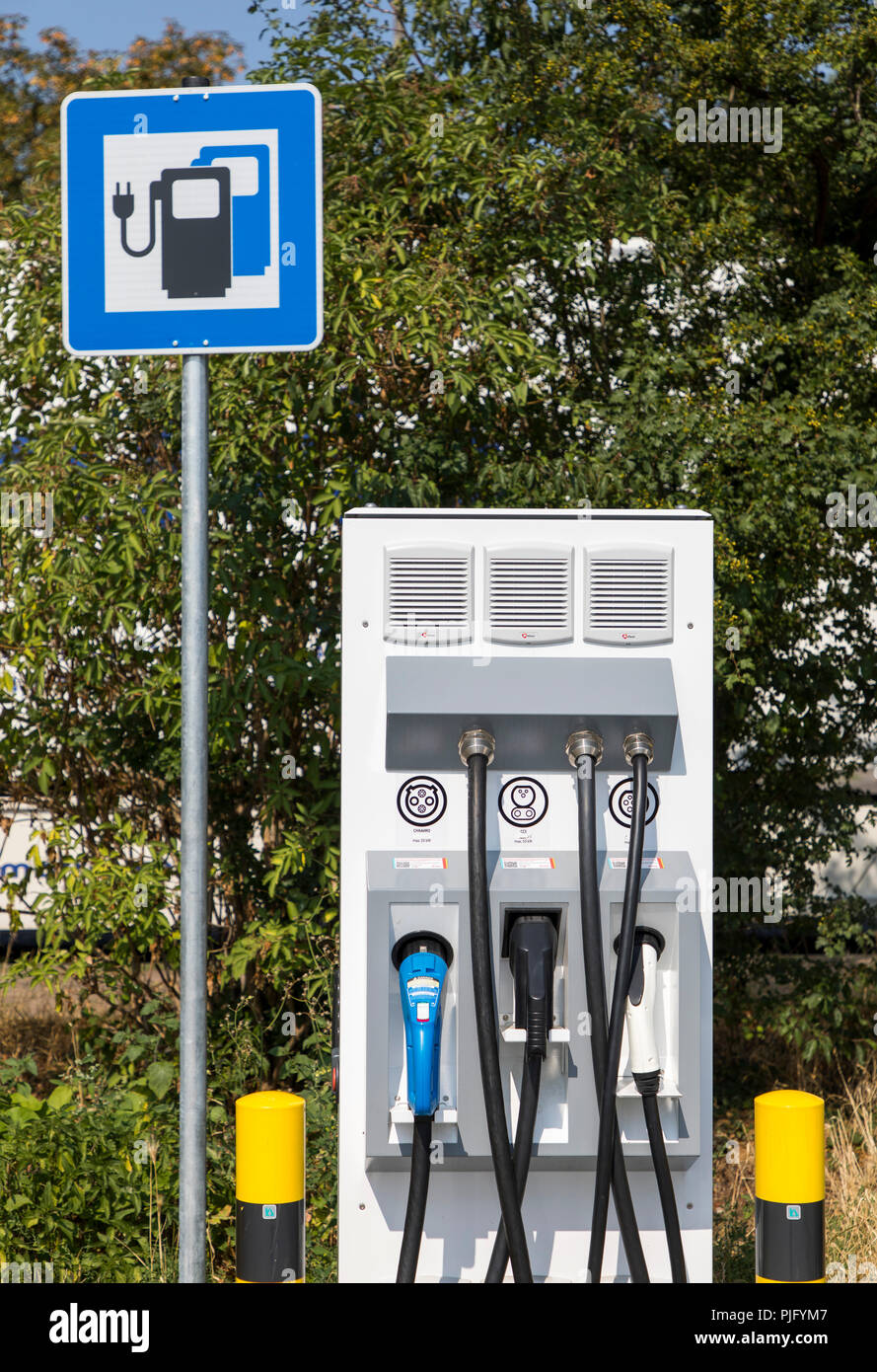 Charging station for electric vehicles, with charging cable and plug for various models, on a motorway service area, Germany Stock Photo