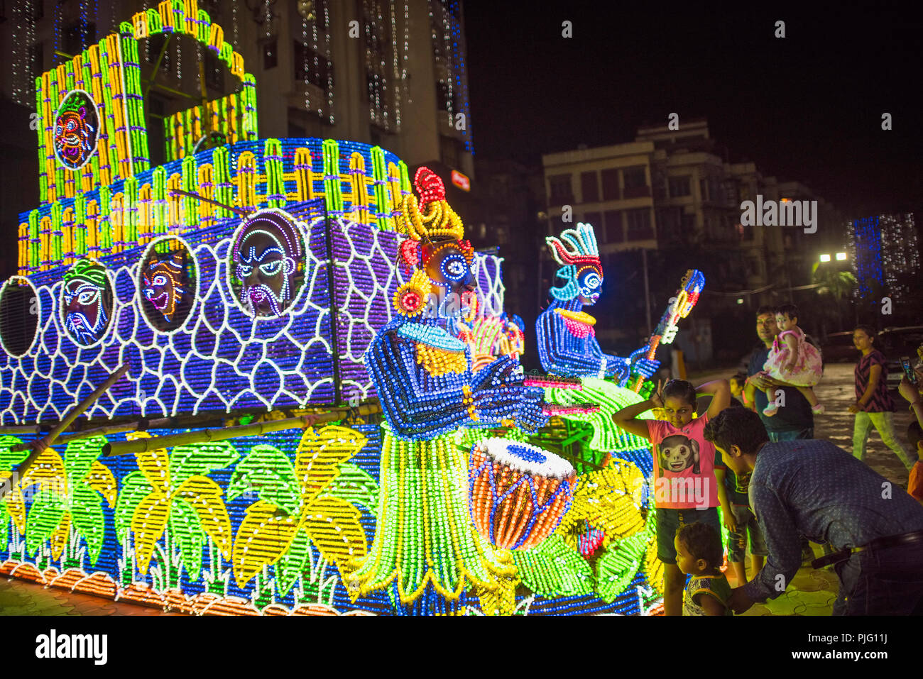 Electrical,lighting,iilumination,of tribal drummers ,children,parents