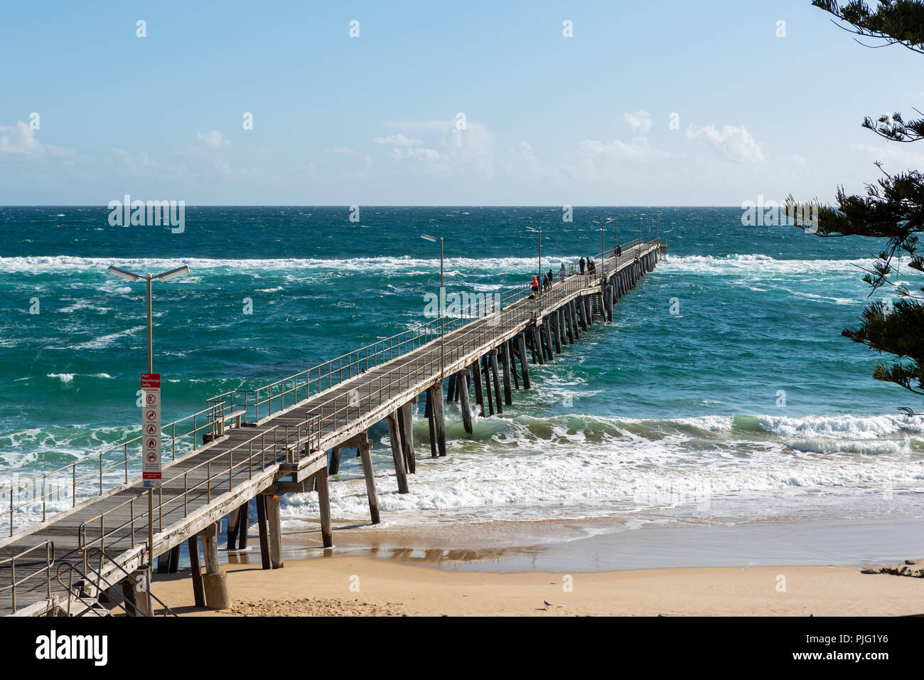 The Port Noarlunga Jetty with rough seas and people fishing in South Australia on the 6th September 2018 Stock Photo