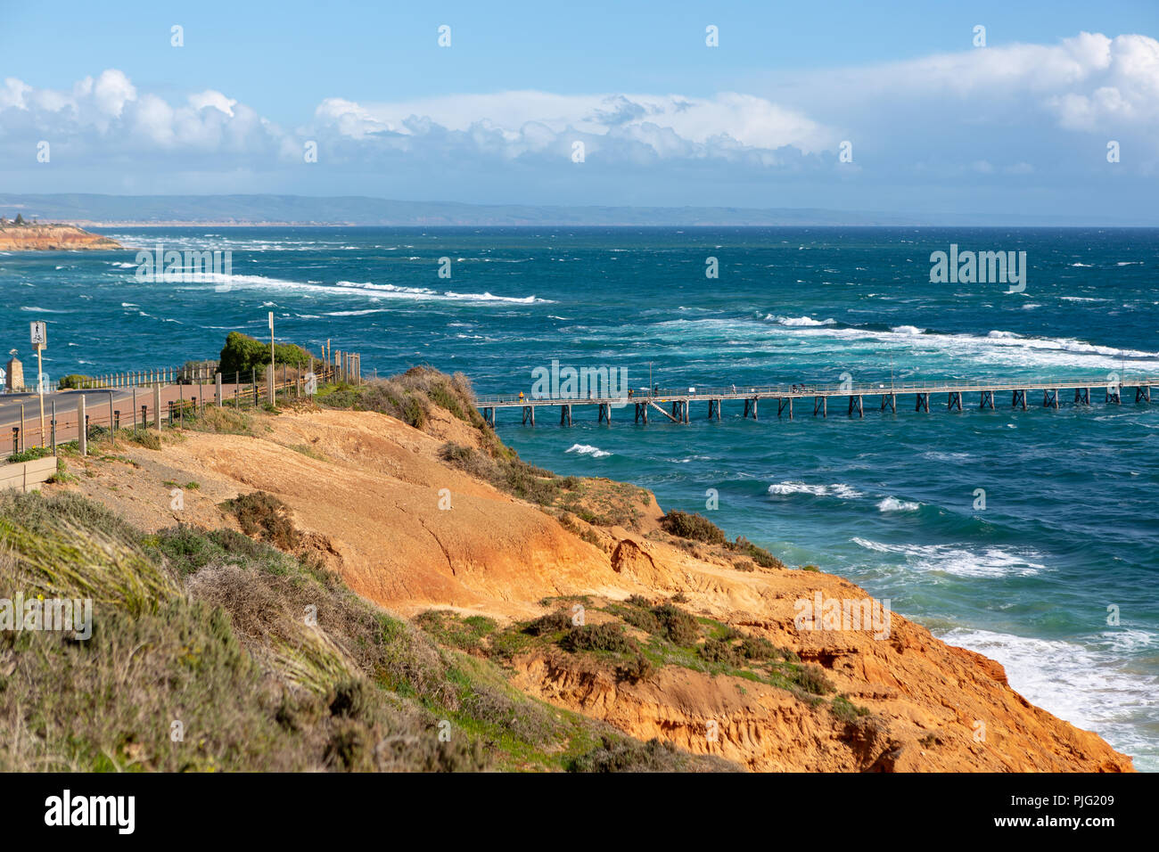 The Port Noarlunga Jetty in rough seas from the northern cliff face in South Australia on the 6th September 2018 Stock Photo