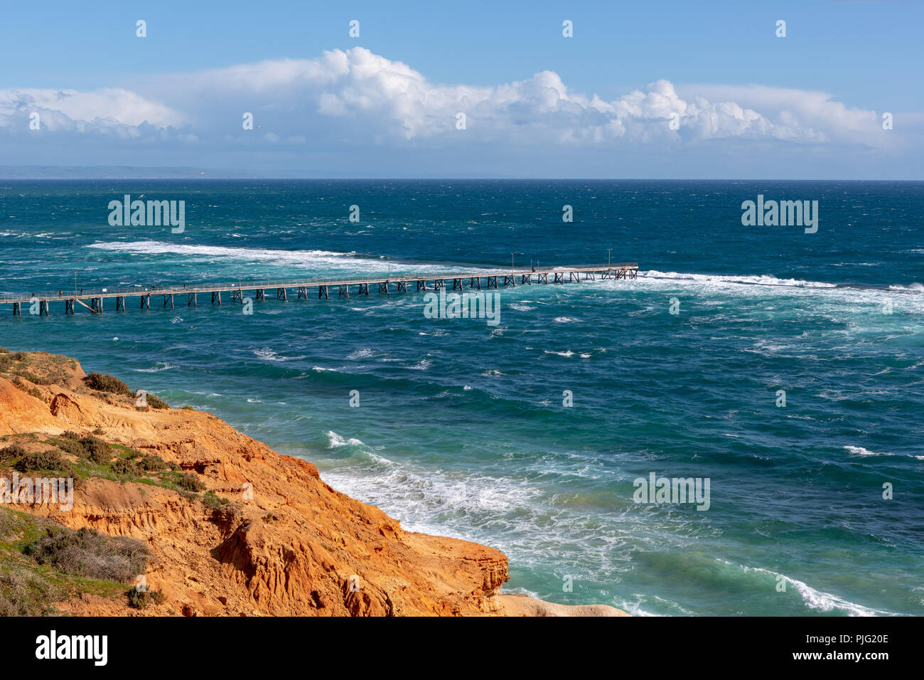 The Port Noarlunga Jetty in rough seas from the northern cliff face in South Australia on the 6th September 2018 Stock Photo