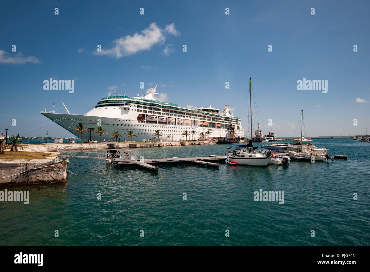 King's Wharf Bermuda - a Royal Caribbean cruise ship is docked next to sailboats in the aquamarine waters of the Bermuda port of call Stock Photo