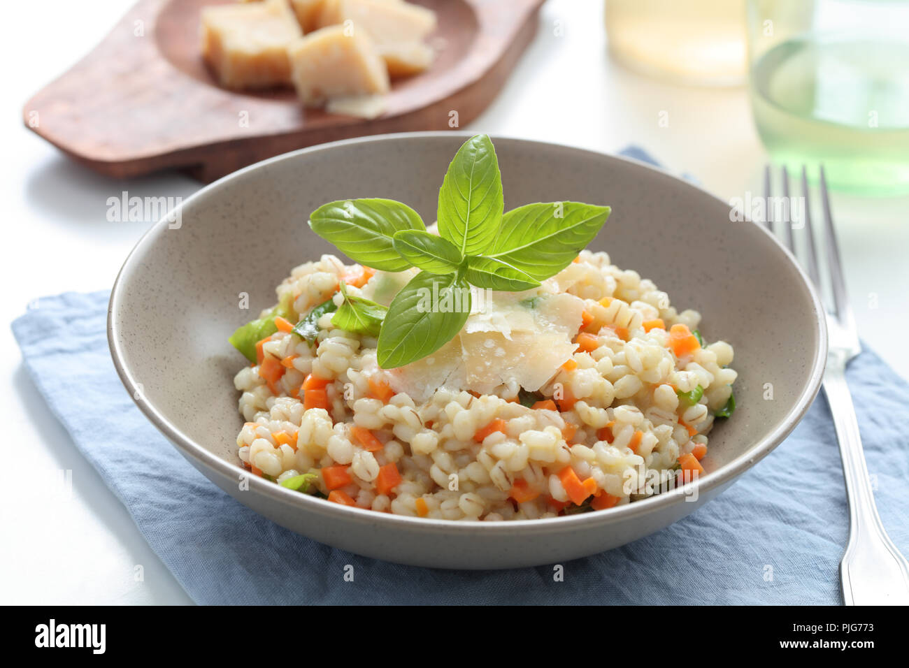Pearl barley risotto with Parmesan cheese and basil Stock Photo Alamy