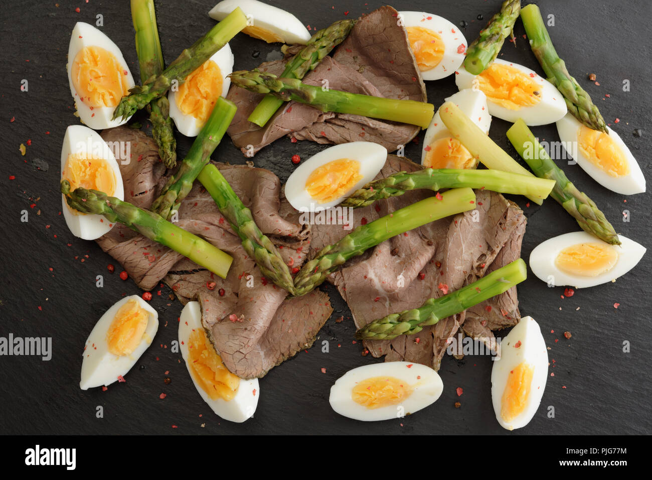 Roastbeef, asparagus, and boiled eggs salad background Stock Photo