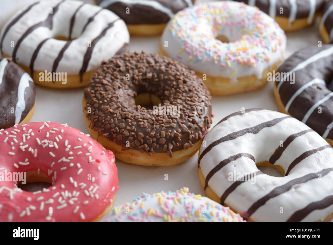 Assorted sweet donuts in a paper box Stock Photo - Alamy
