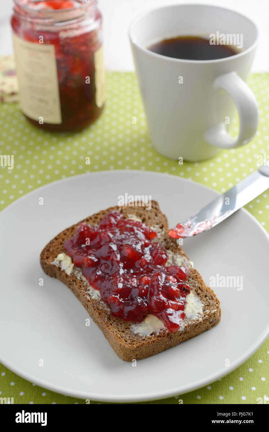 Sandwich with butter and lingonberry jam Stock Photo