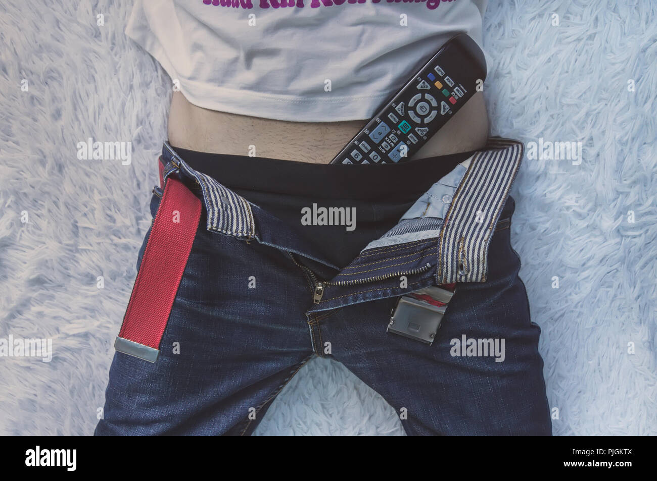 man-lying-in-bed-and-watching-tv-with-th