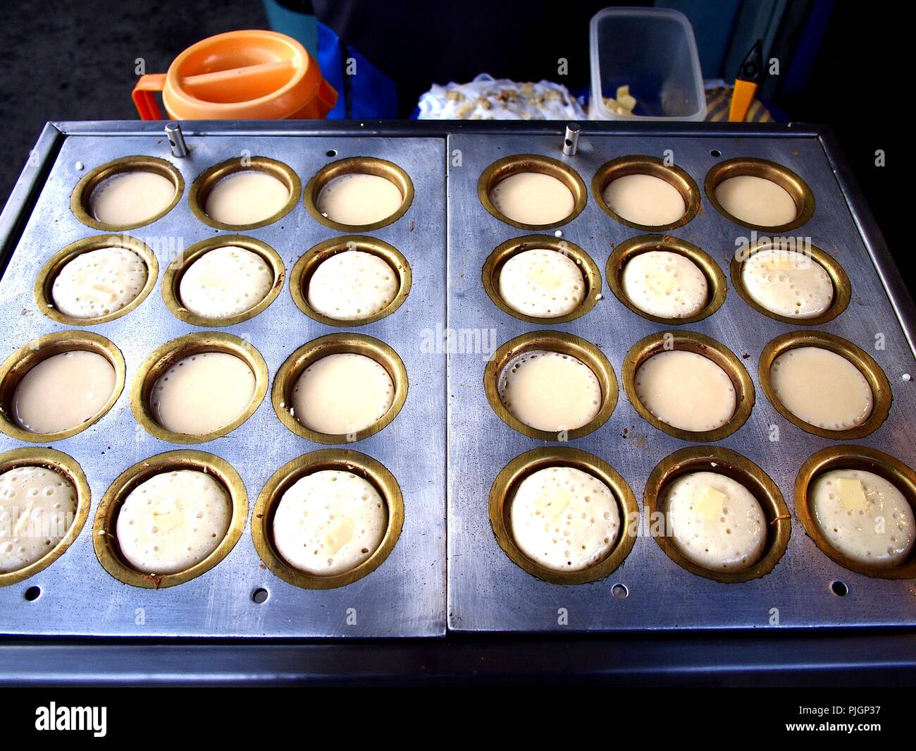 Photo of mini japanese pancakes being cooked on a food cart Stock Photo