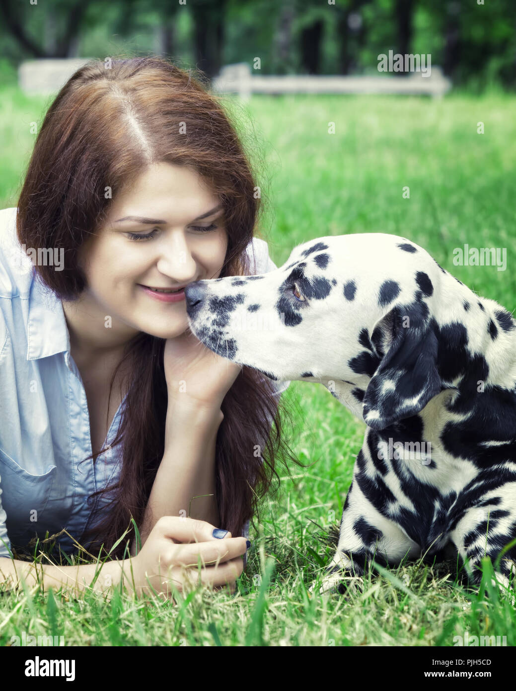 Pretty beautiful woman with long dark hair with dalmatian dog Stock Photo