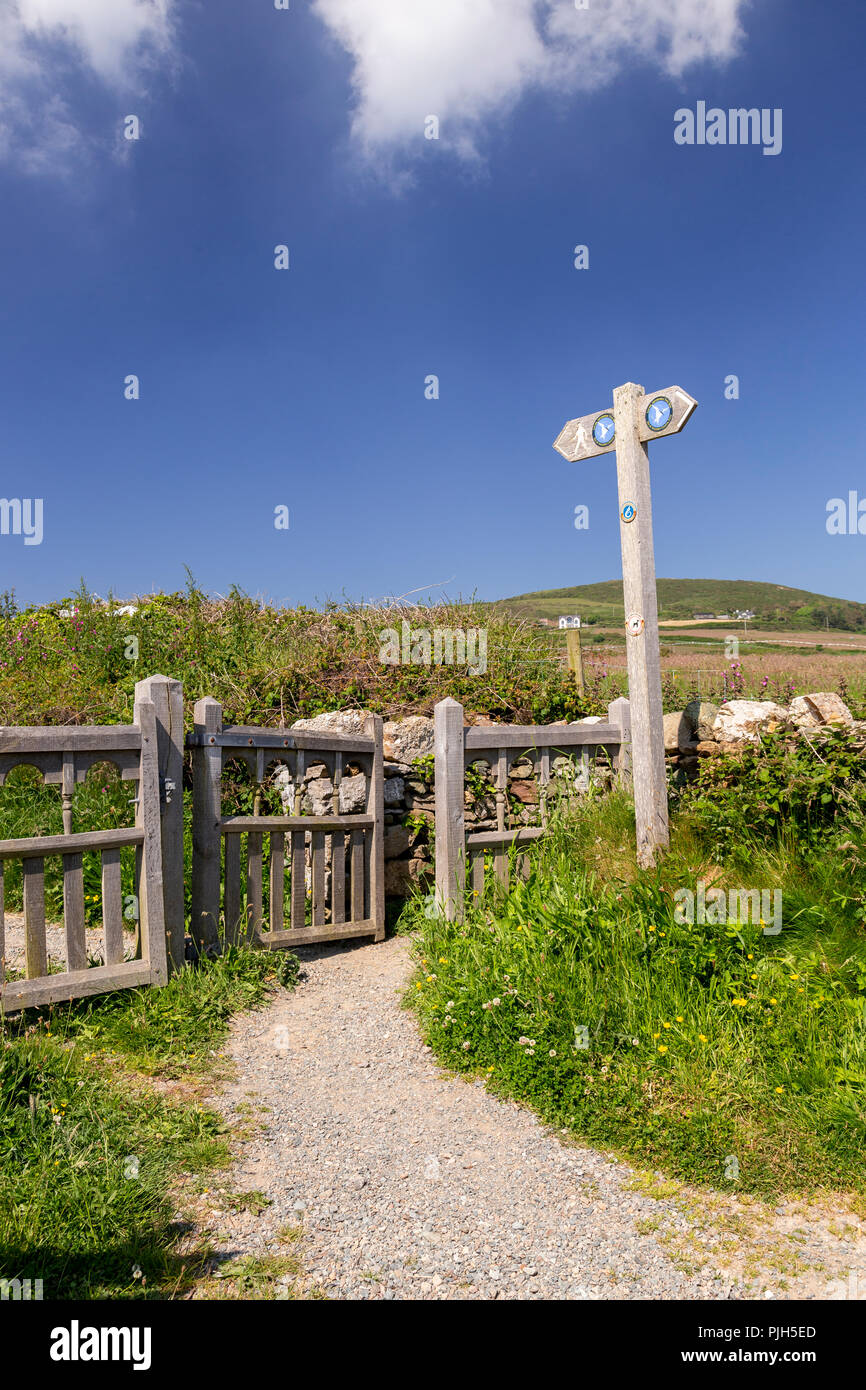 Anglesey coastal path gate and signpost at Church Bay, Anglesey, North Wales on a sunny summer's day Stock Photo