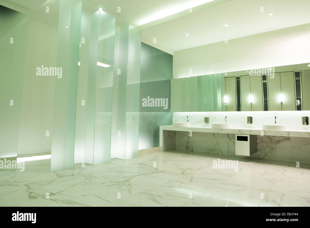 the glass wall and good lighting setup in the elegant public restroom Stock Photo