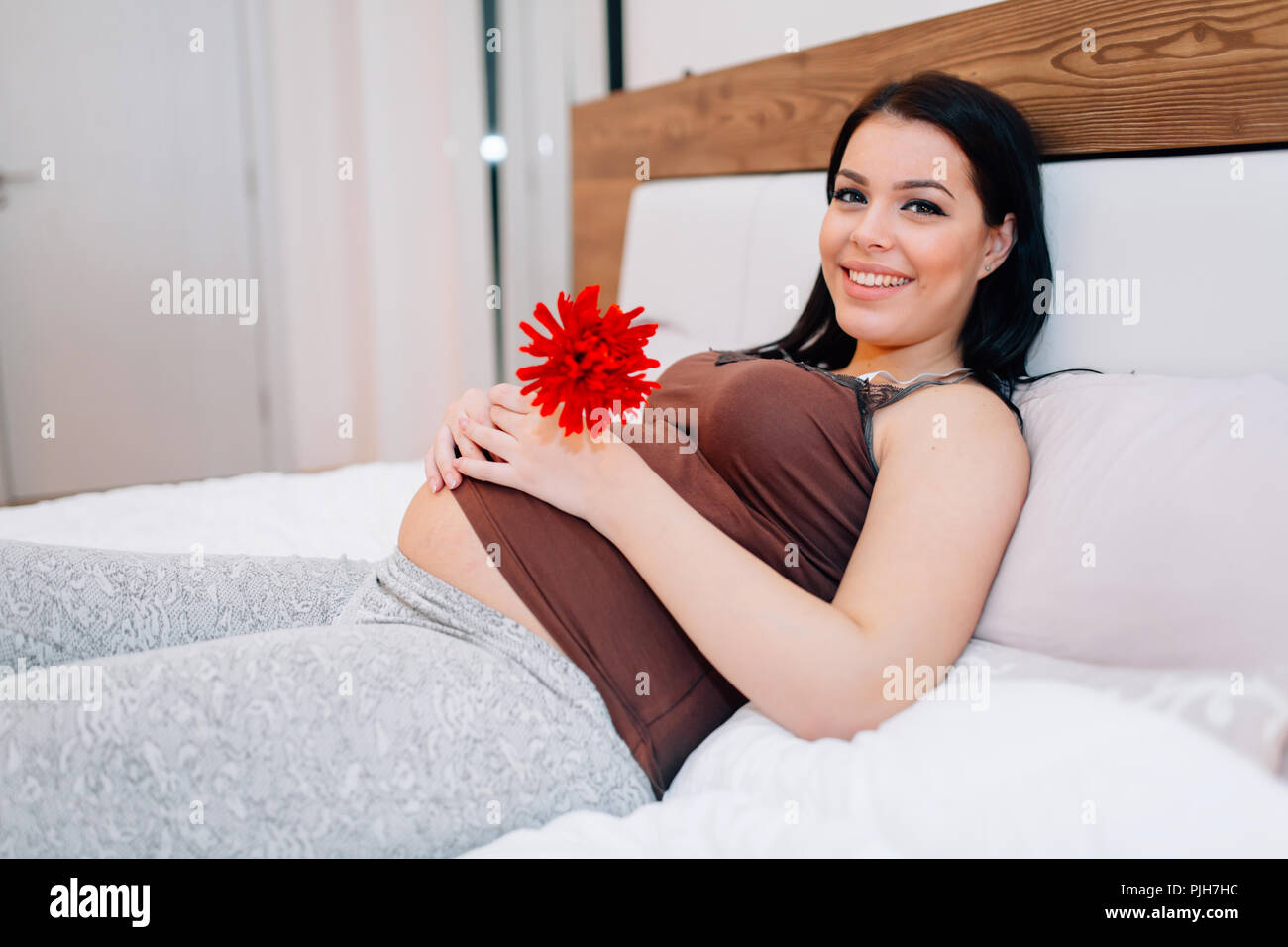 Pregnant woman happy for flower Stock Photo