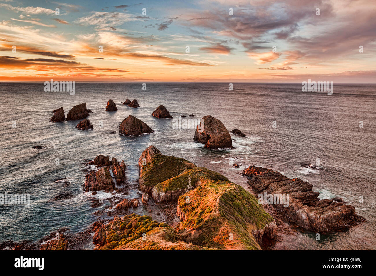 Rocks and sea stacks at Nugget Point Otago New Zealand, sunrise. Stock Photo