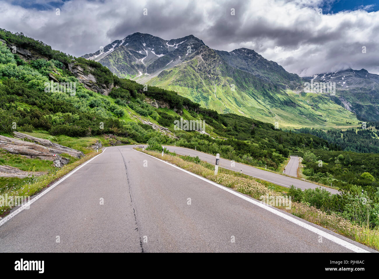 Curvy pass road San Bernadino Pass, with clouds, canton of Grisons, Switzerland Stock Photo