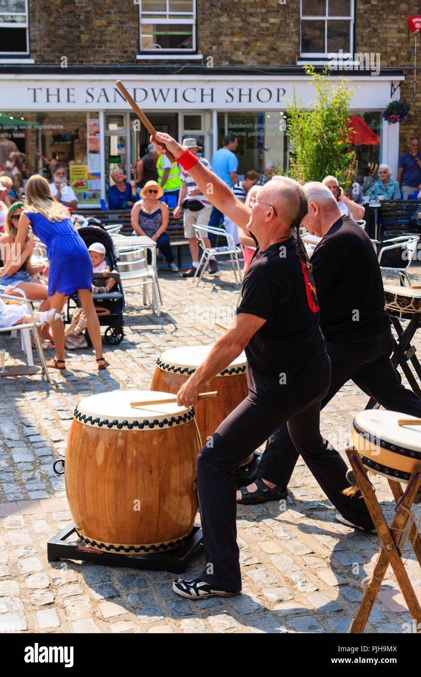 English Caucasian group, Kensei Taiko performing traditional Japanese drumming in Sandwich Town square during the yearly Folk and Ale Festival Stock Photo