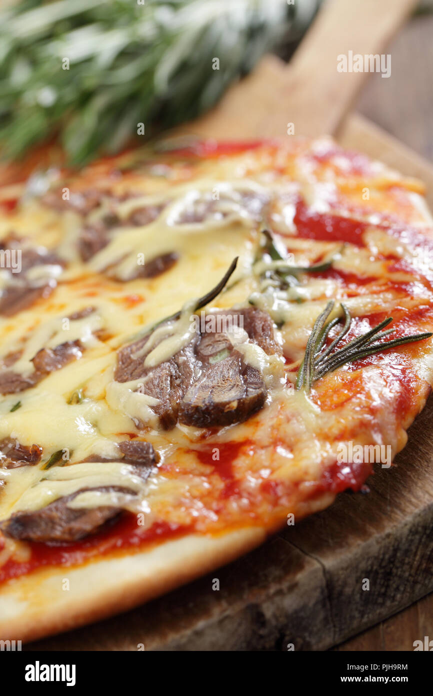 Pizza with lamb meat, cheese, and rosemary Stock Photo Alamy