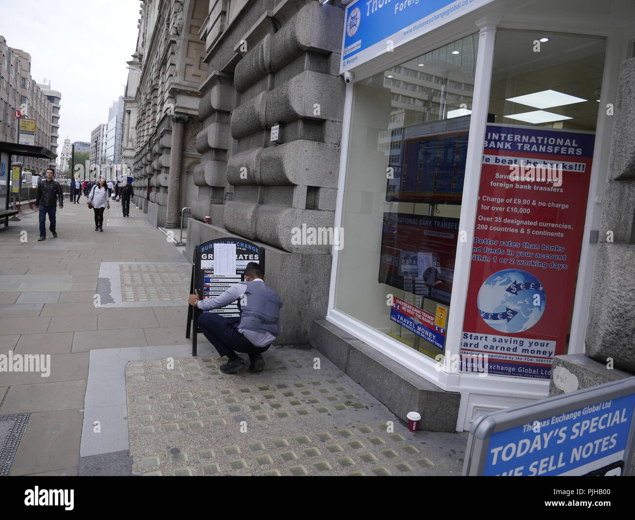 Assistant marks up exchange rates on board at Thomas Exchange Global  Limited, Bureau de Change, Currency Exchange, London, UK Stock Photo - Alamy