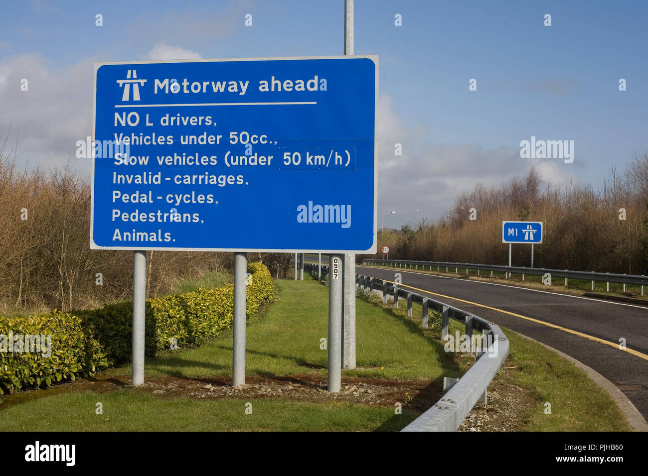 Northbound entry to M1 Dublin to Belfast motorway at junction 6 with sign of prohibited traffic Stock Photo